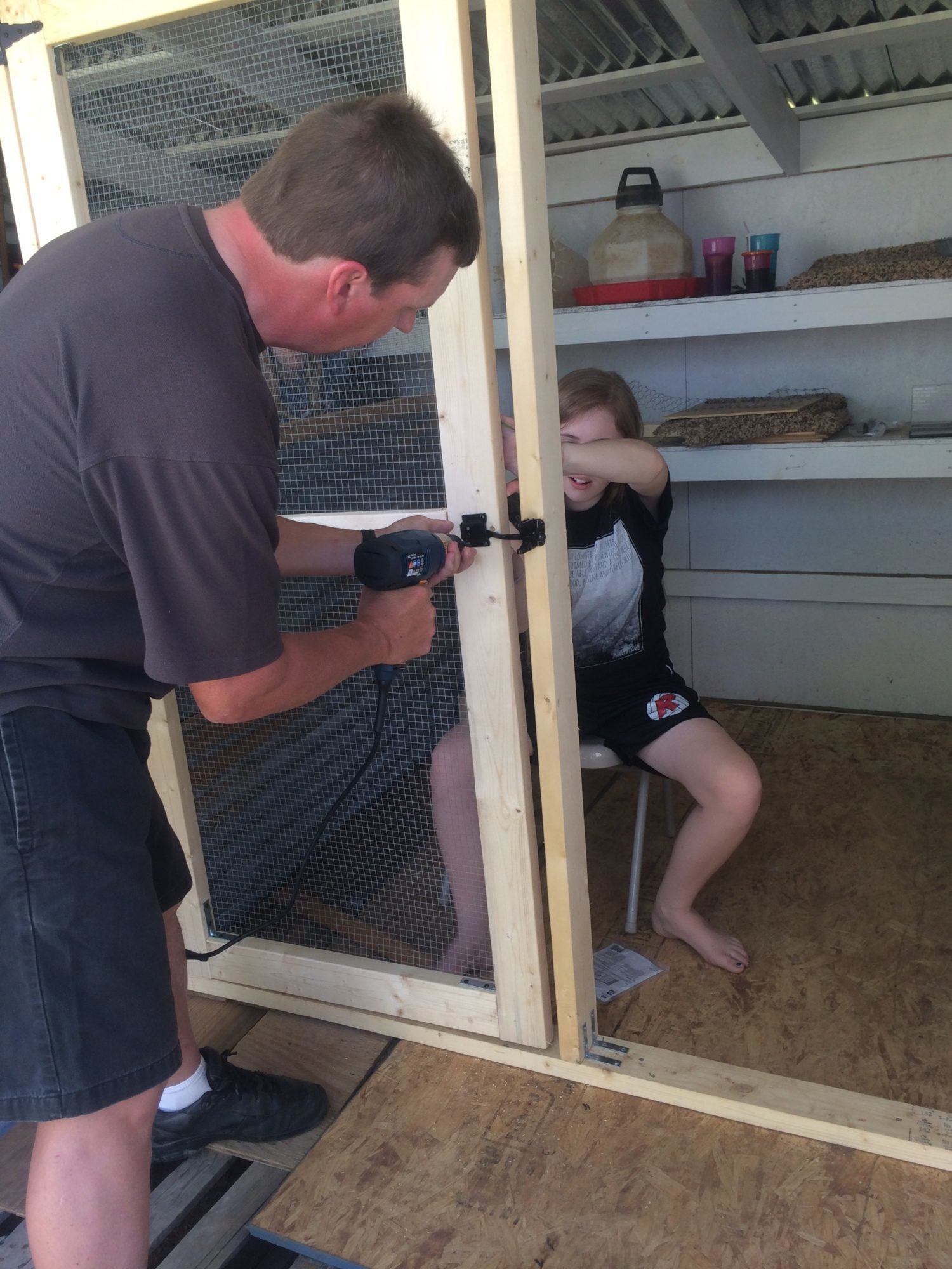 We designed and built our screen door. My husband and 13-year old daughter are putting it up.