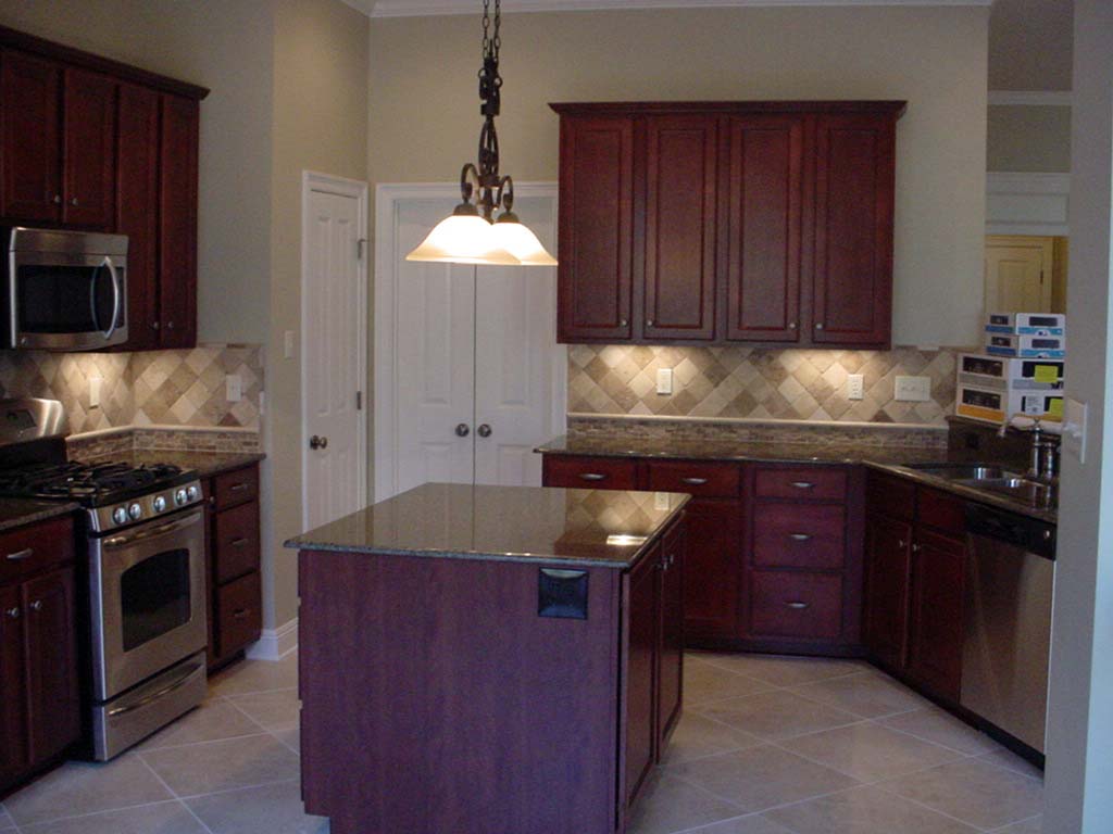 We installed the trim moldings, cabinets, wood flooring, and all tile on this job.