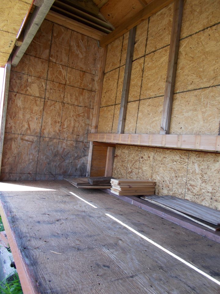 We used some OSB for the sides - as long as you paint the outside, it should hold up against the weather.  You can see the area at the bottom right of this pic that will eventually be the area for the nest boxes.  We also added about 3 branches for roosts that we just used screws to hold up.