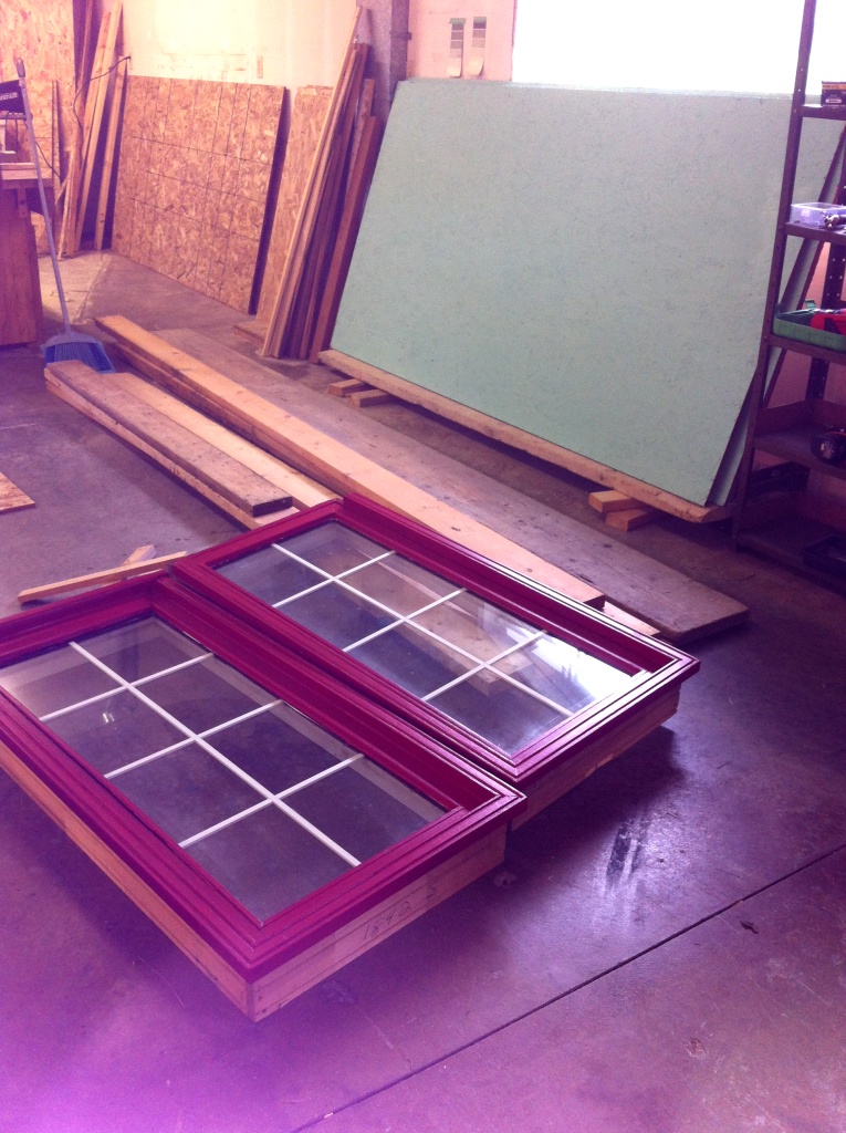 Windows donated from friends that I refinished  blue ceiling and wall panels just finished painting