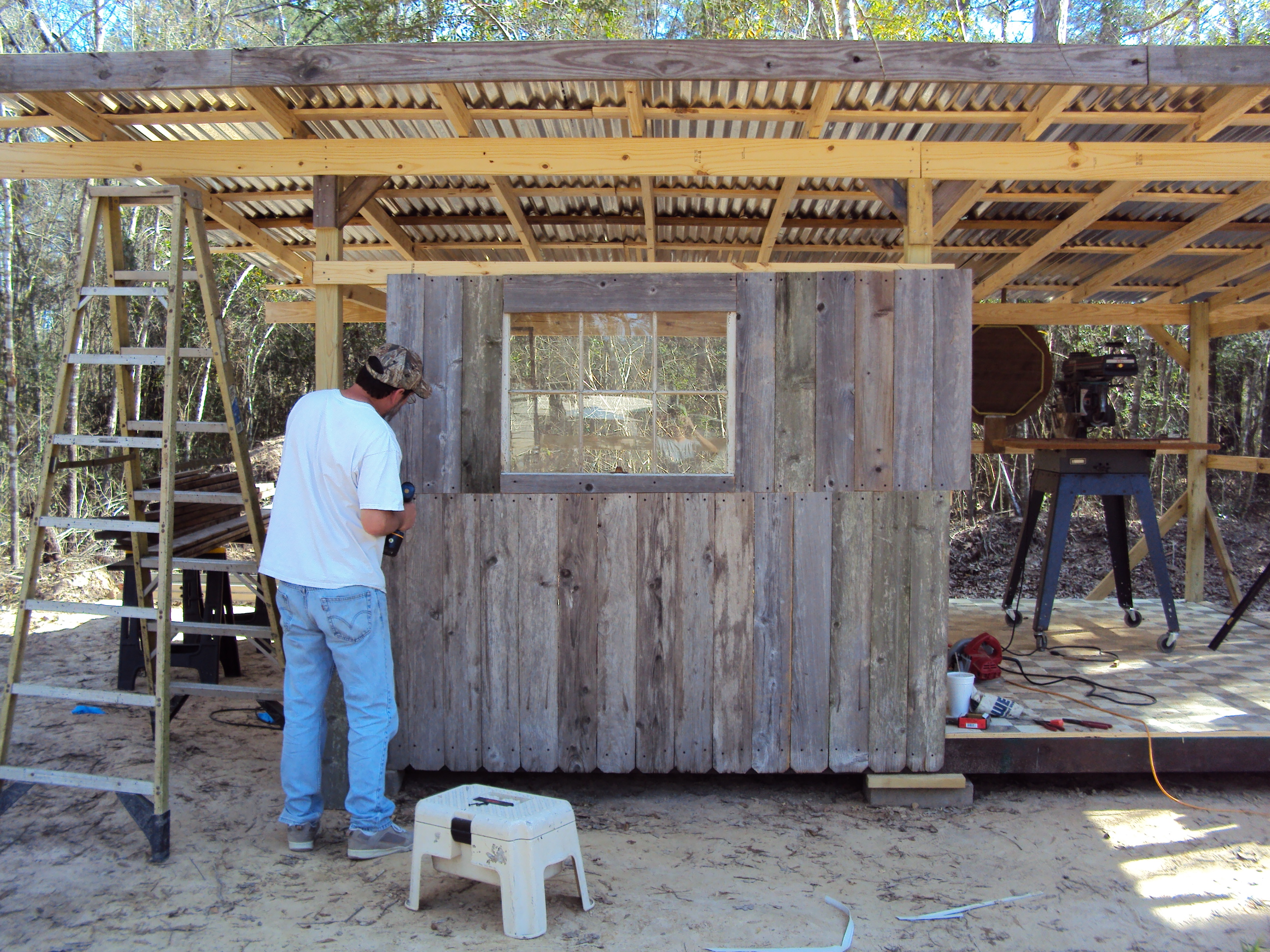 Working on front wall.  Walls are made from recycled cedar fence.  Each board is custom measured and cut by Keith to fit just right.