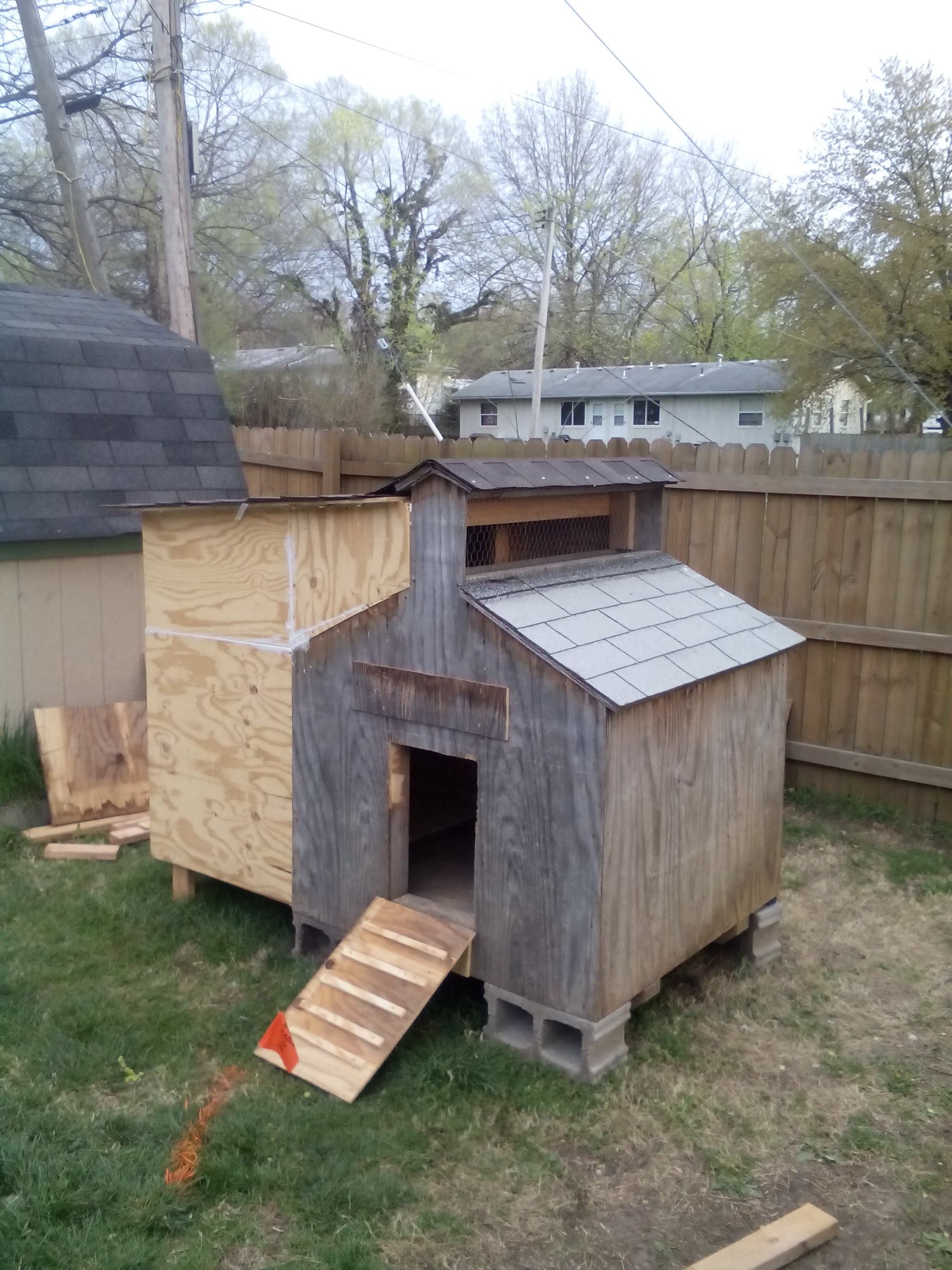 You can (obviously) see where we added on. The chicken ramp was a fun project for my hubby and youngest daughter. She got to help screw on the cleats. Yes, that's big when you are seven. The orange line? Cable wire. Even marked, we still cut through it. Hey, we are never for a lack of entertainment around here....