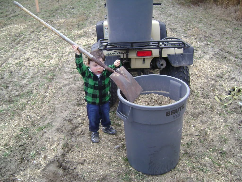 LucasshovelingFertilizeronfoodplots.jpg