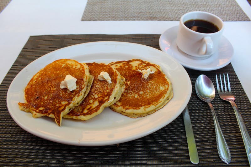 breakfast-hot-cakes-coffee-plate-tree-cup-withe-table-forks-spoon-knife-56042042.jpg
